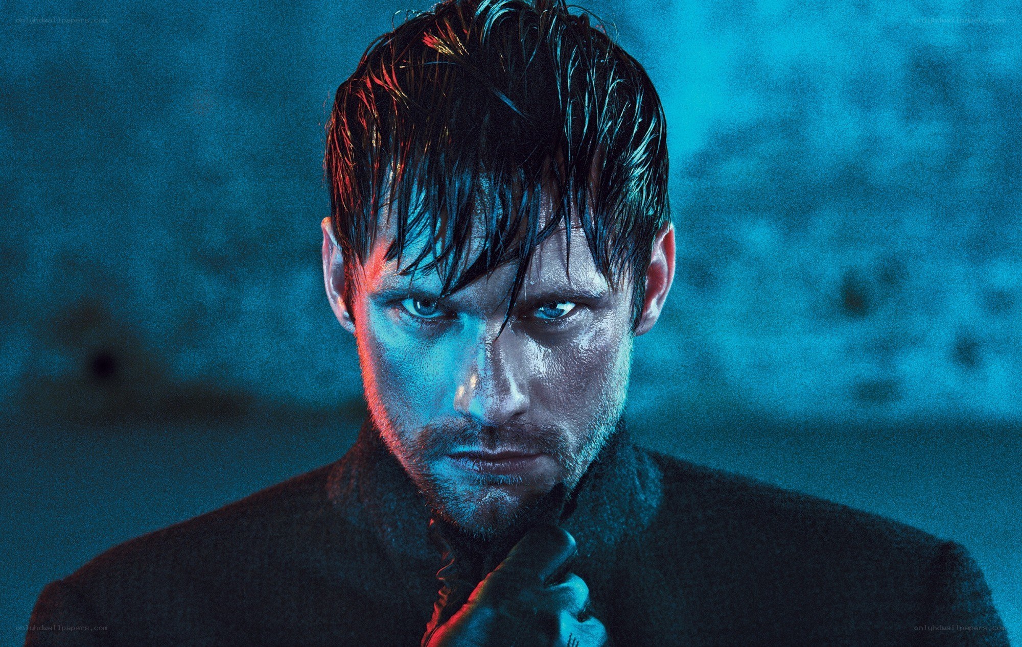 man with wet hair in blue light