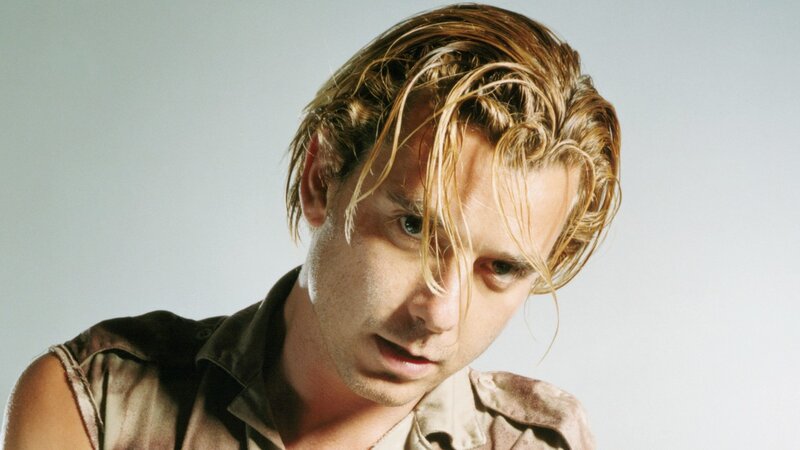 man with wet hair looking down