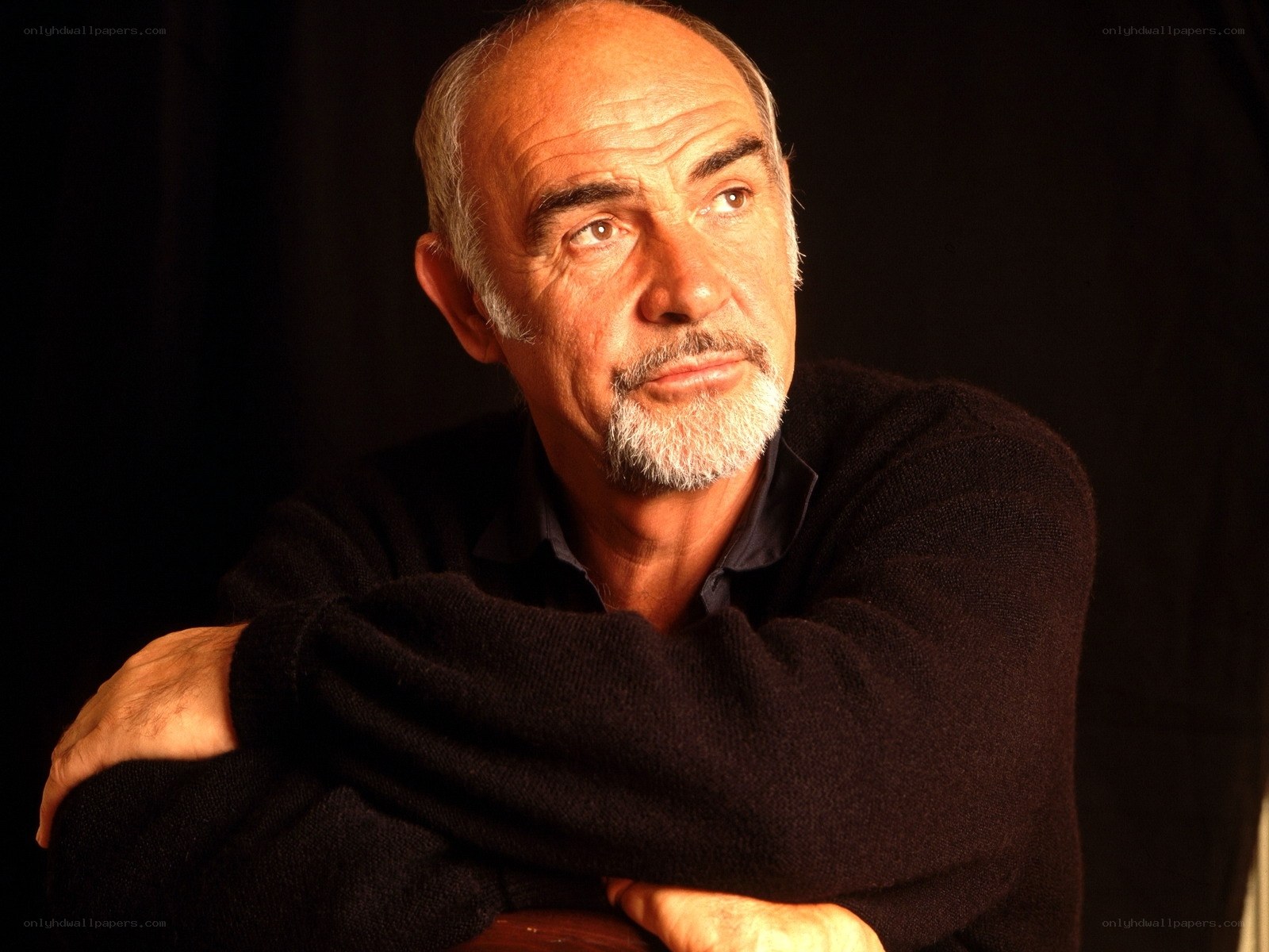 man with white beard in dark sweater