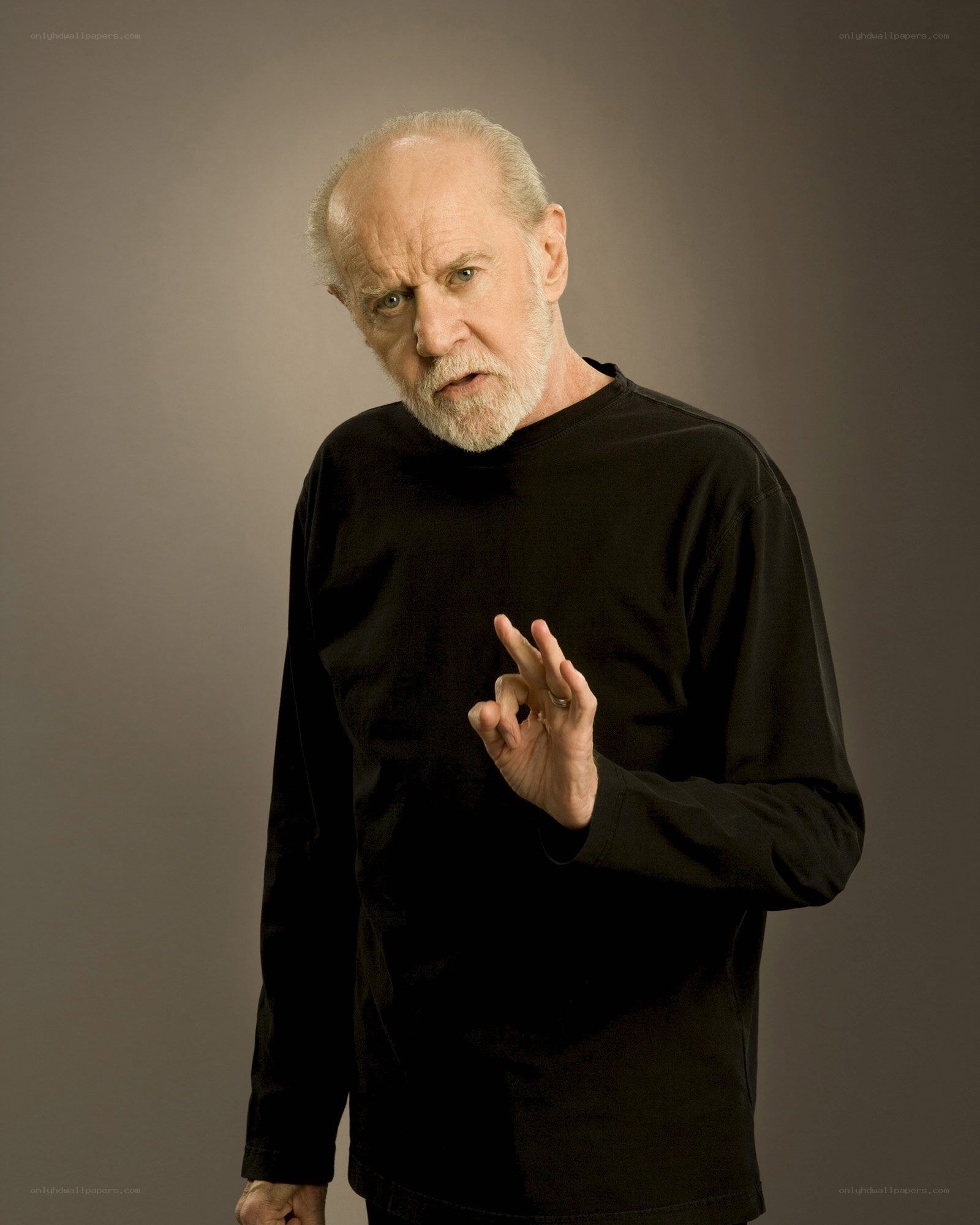 man with white beard making hand gesture