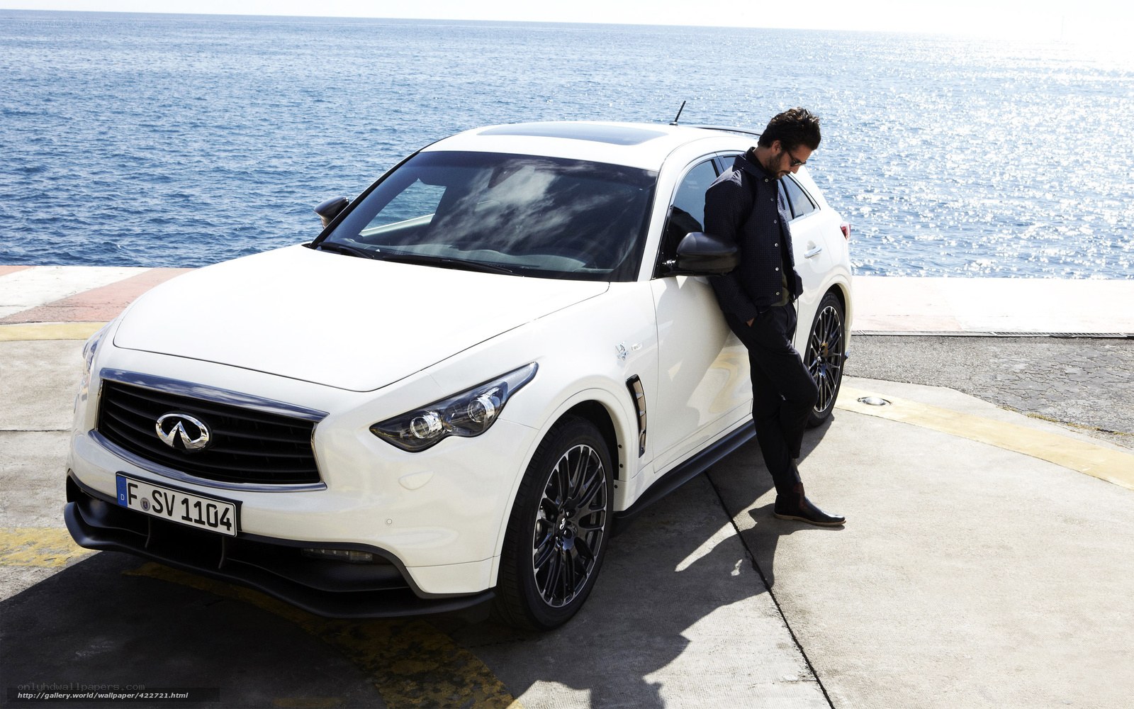 Man with white car by the sea