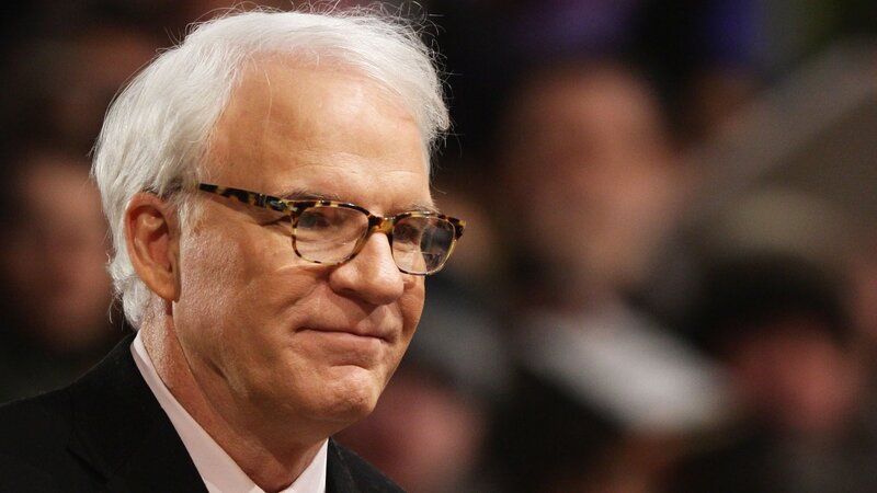 man with white hair and glasses