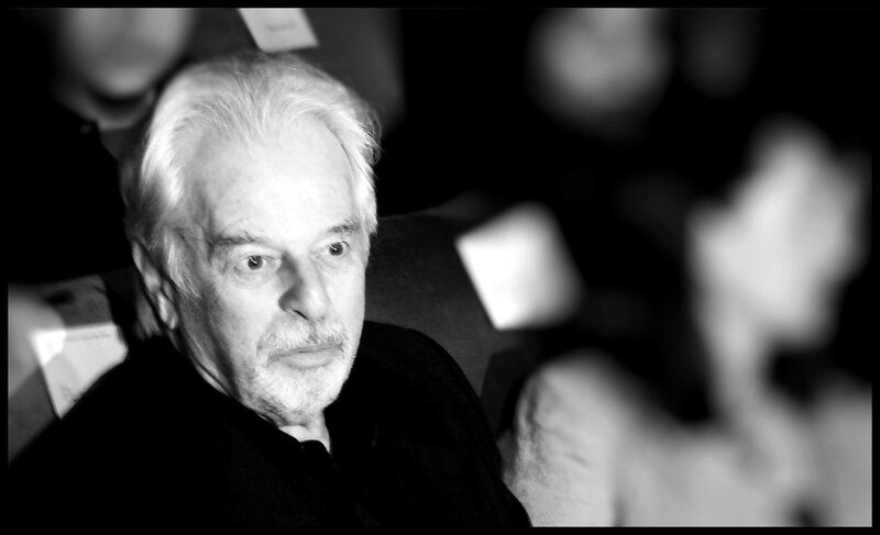 man with white hair in audience