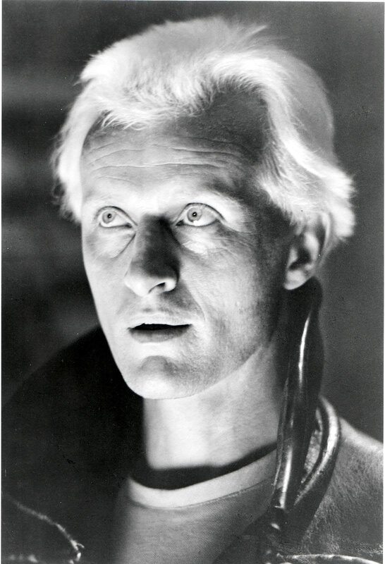 man with white hair in black and white