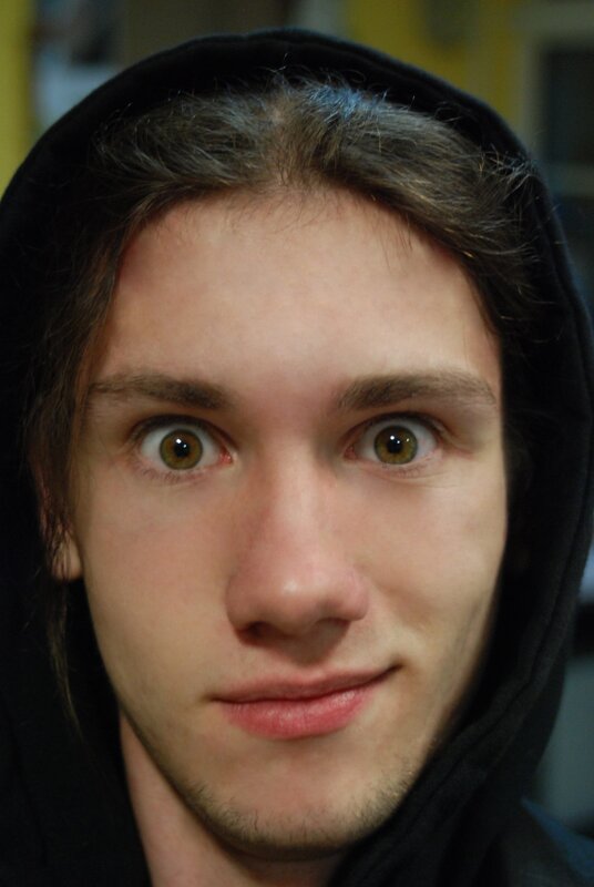 man with wide eyes in hoodie