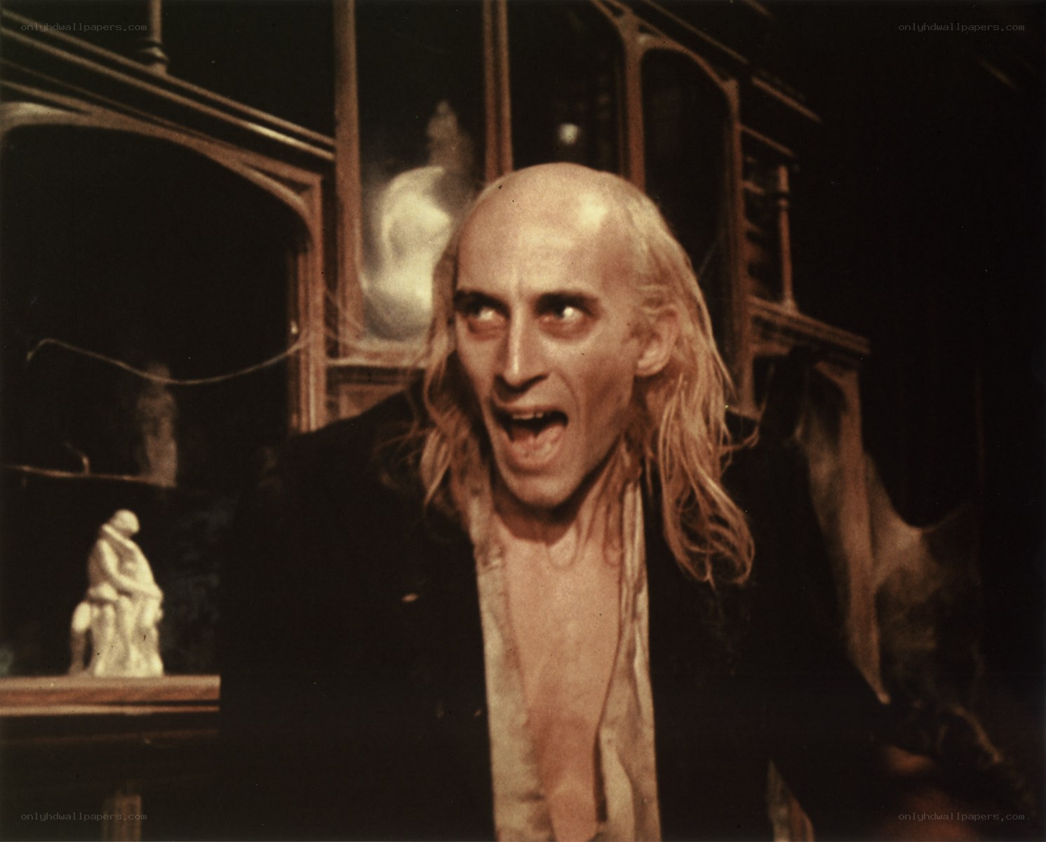 man with wild expression in dark room