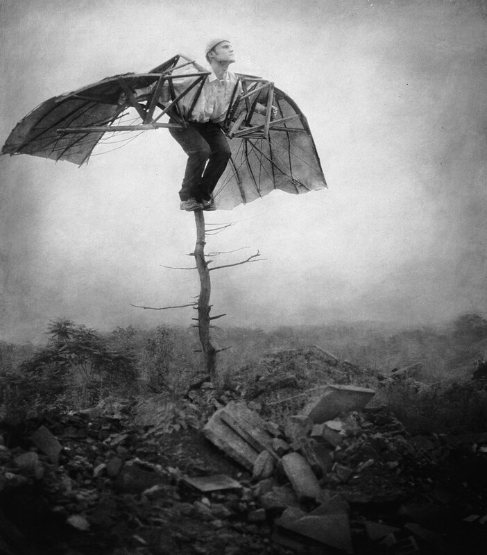 man with wings on a pole