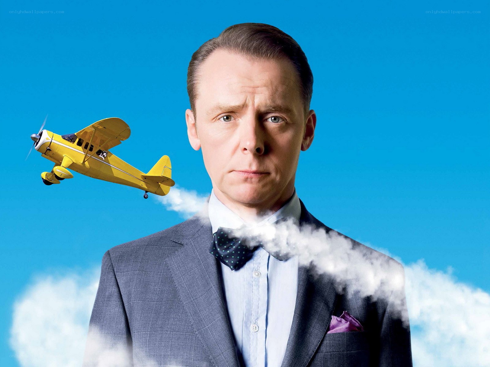 Man with yellow plane in sky