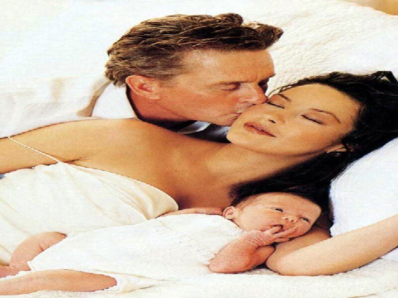 Man Woman Baby in Bed