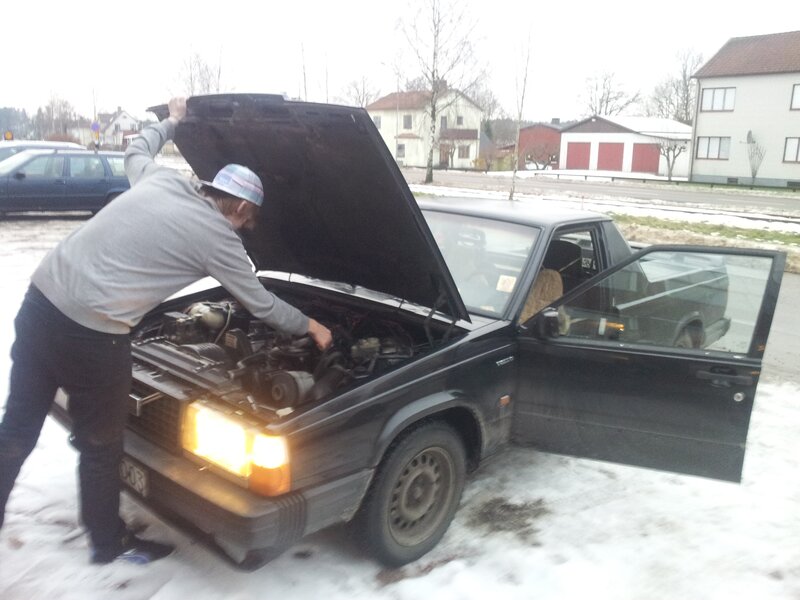 man working on car engine