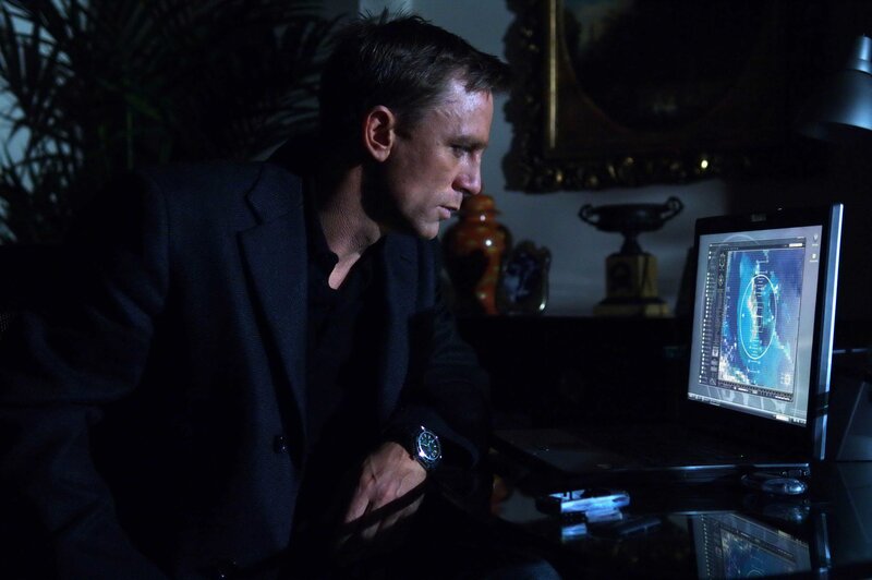 Man working on laptop in dark room