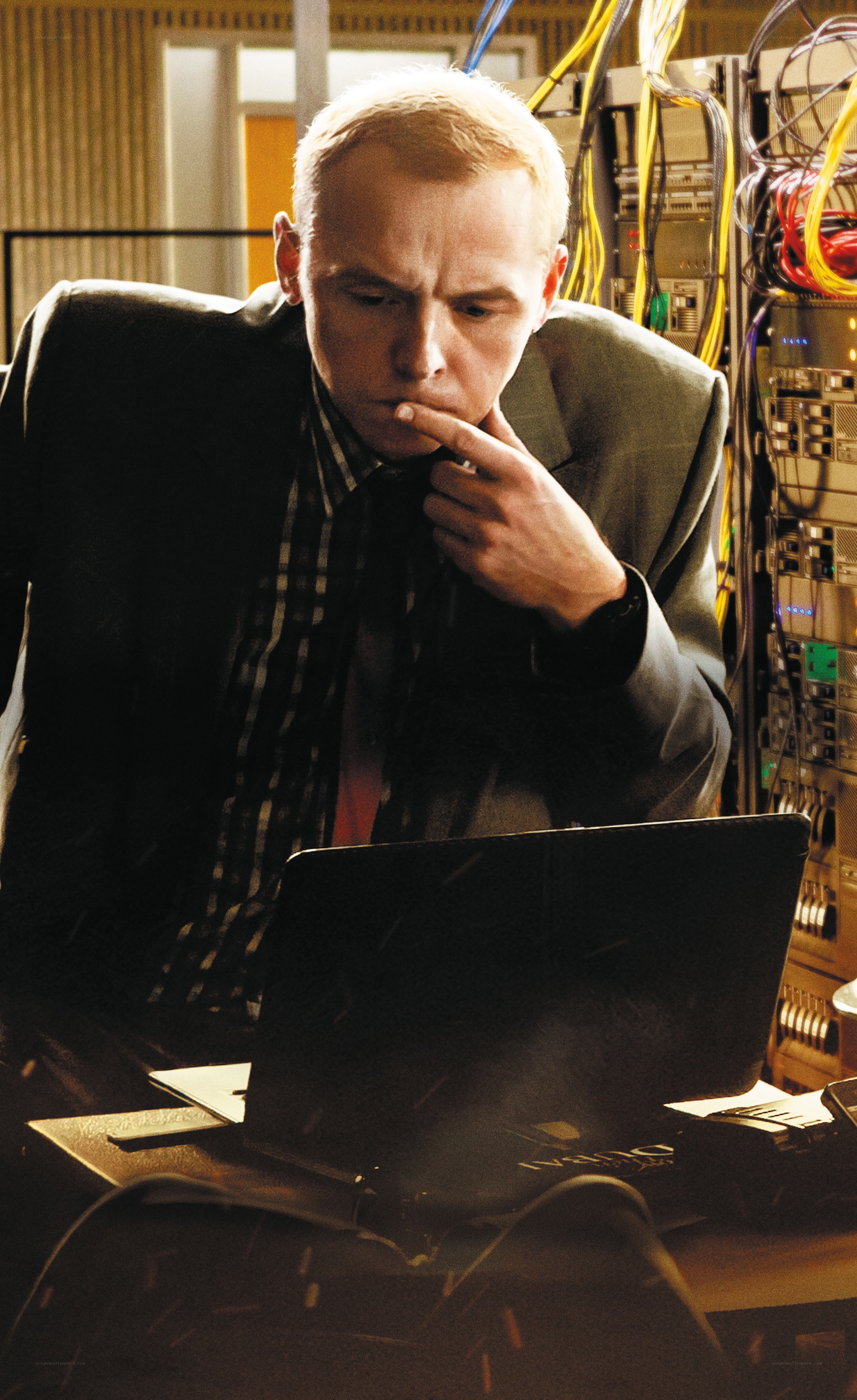 Man working on laptop in server room