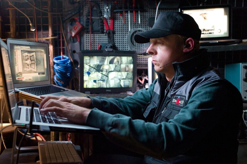 Man working on laptops in workshop