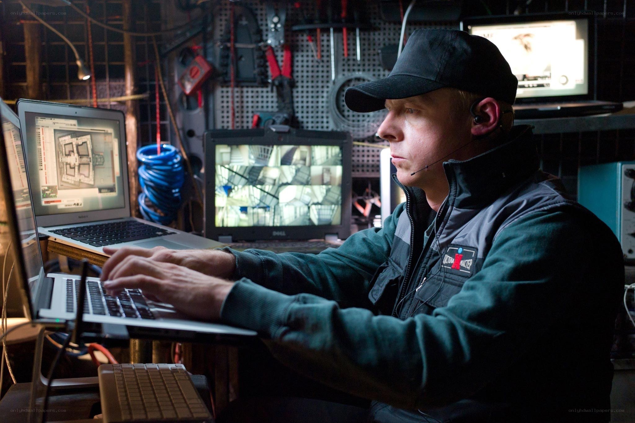 Man working on laptops in workshop