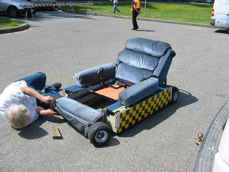 man working on recliner go-kart
