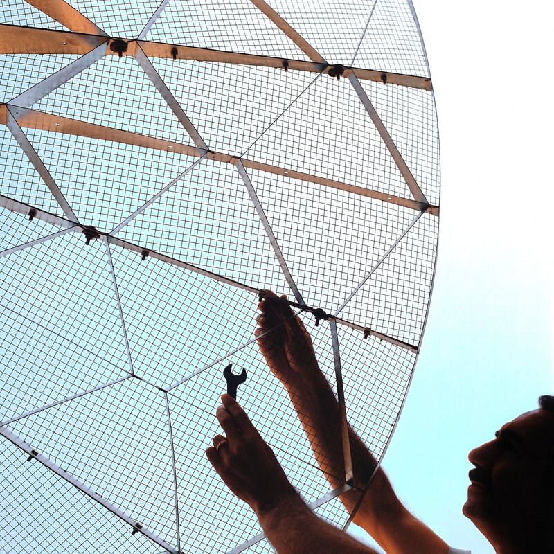 Man working on satellite dish