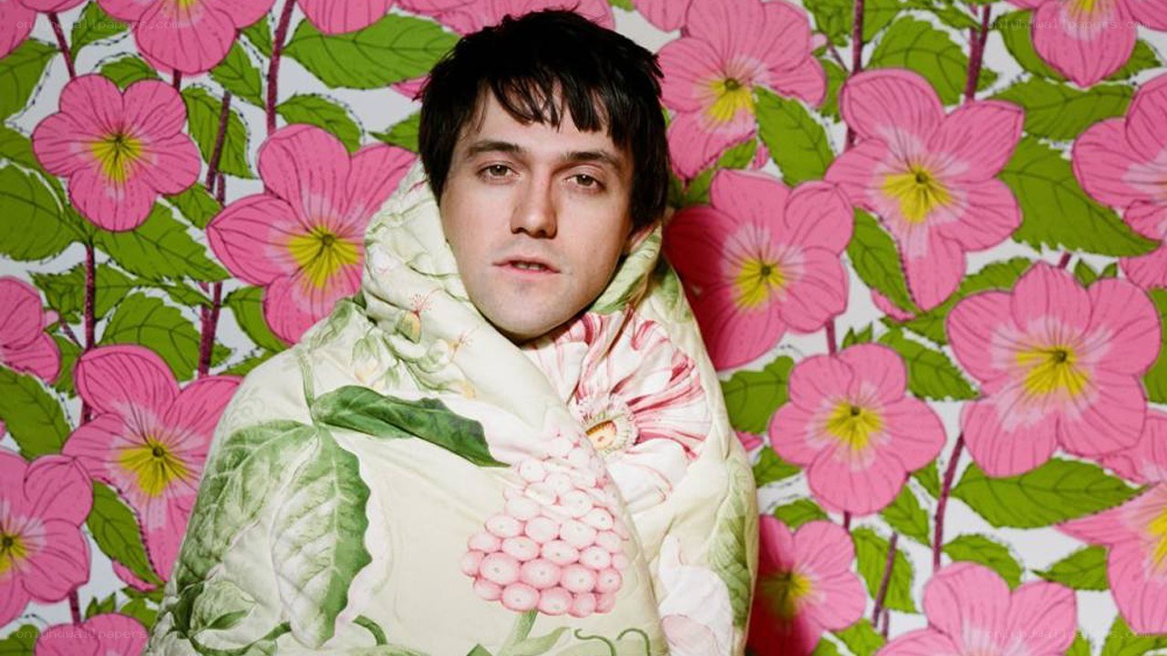 man wrapped in floral blanket