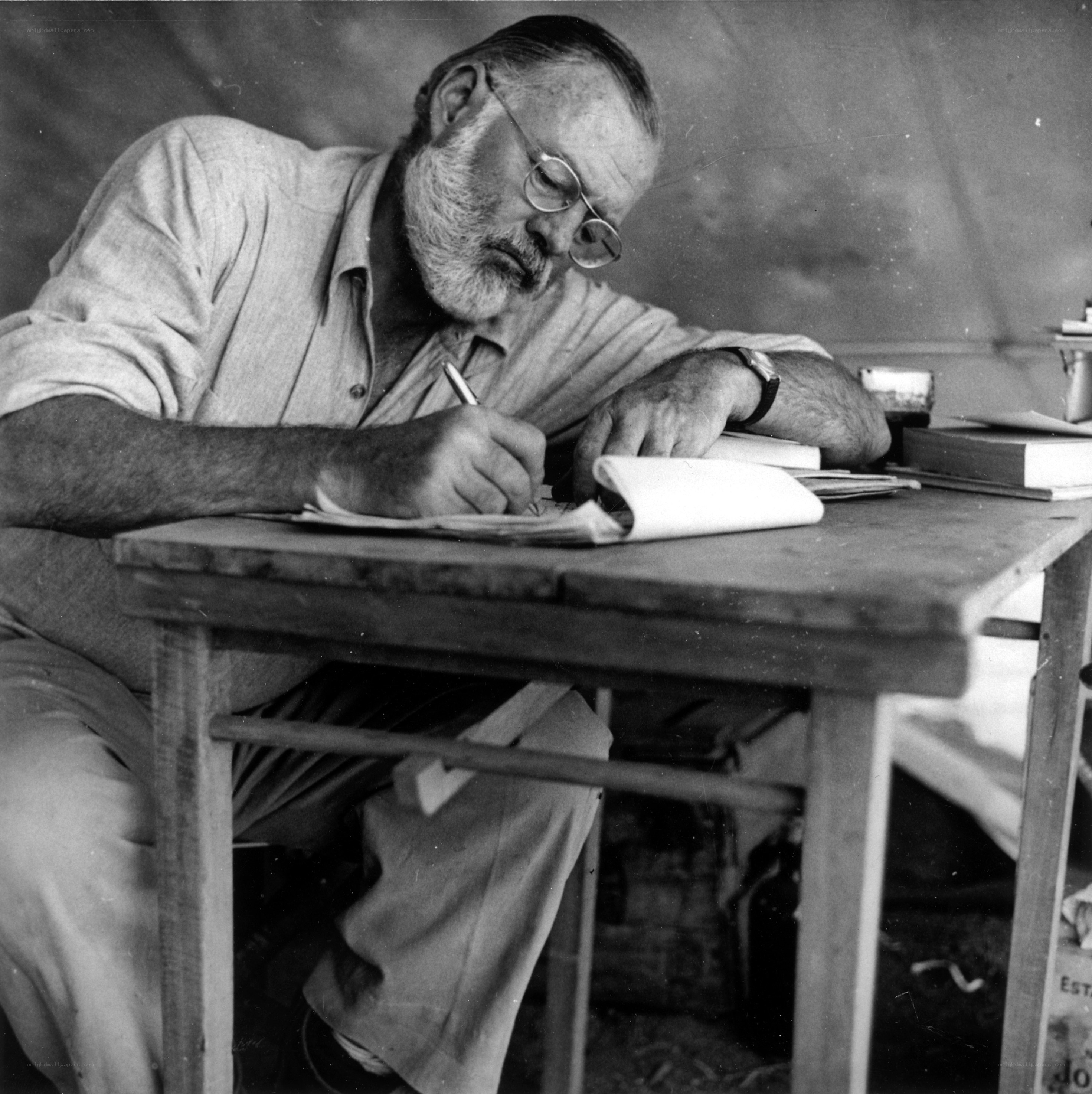 man writing at a desk