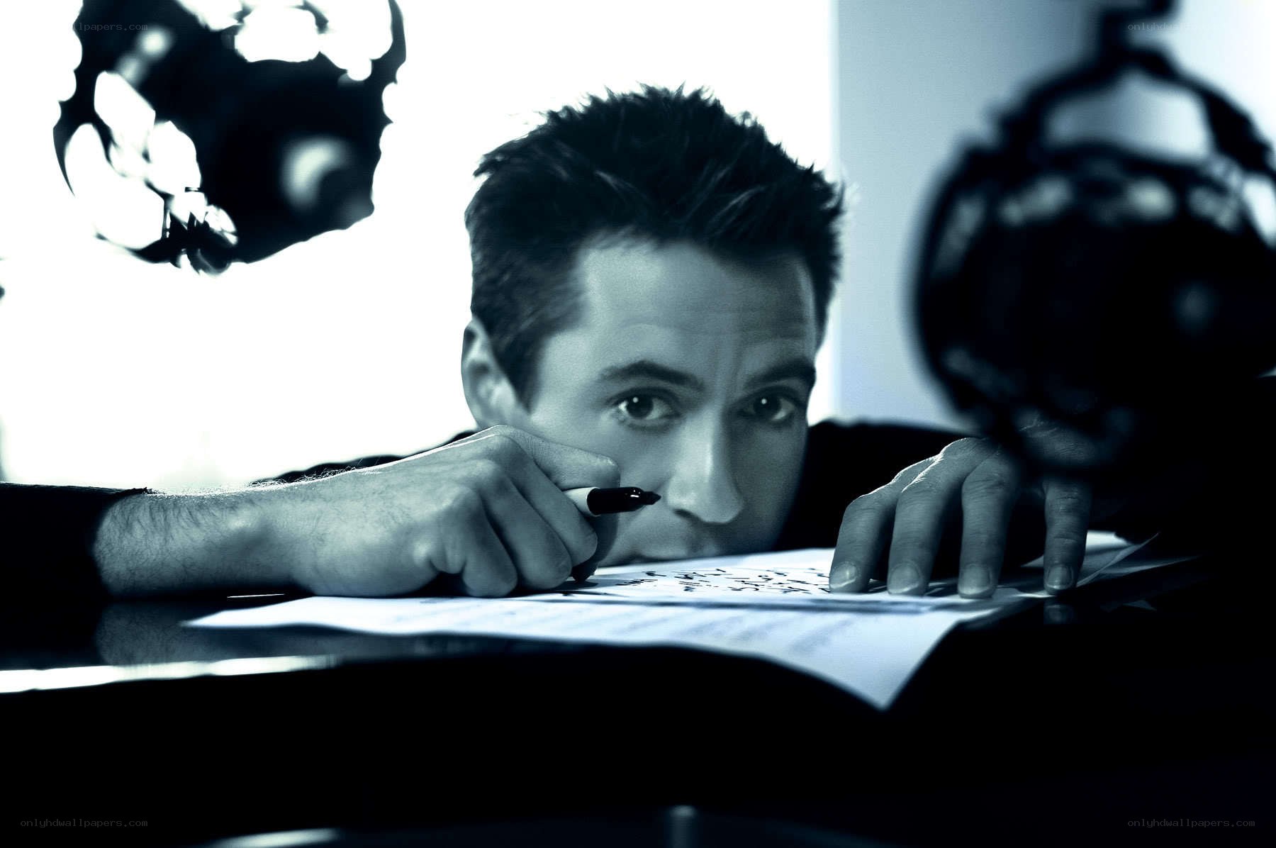man writing at desk