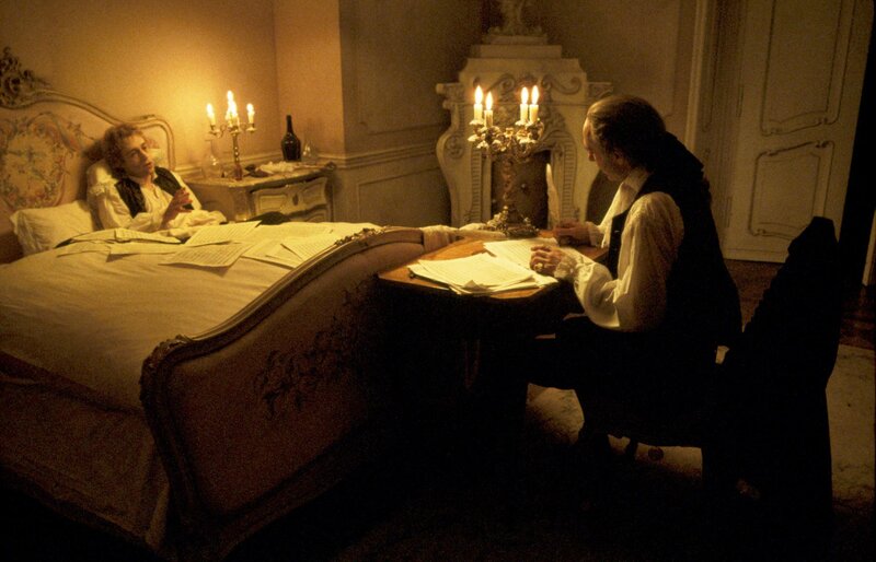 Man writing at desk in bedroom