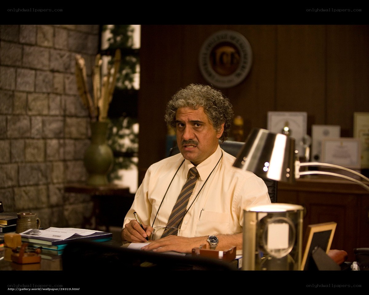 man writing at desk in office