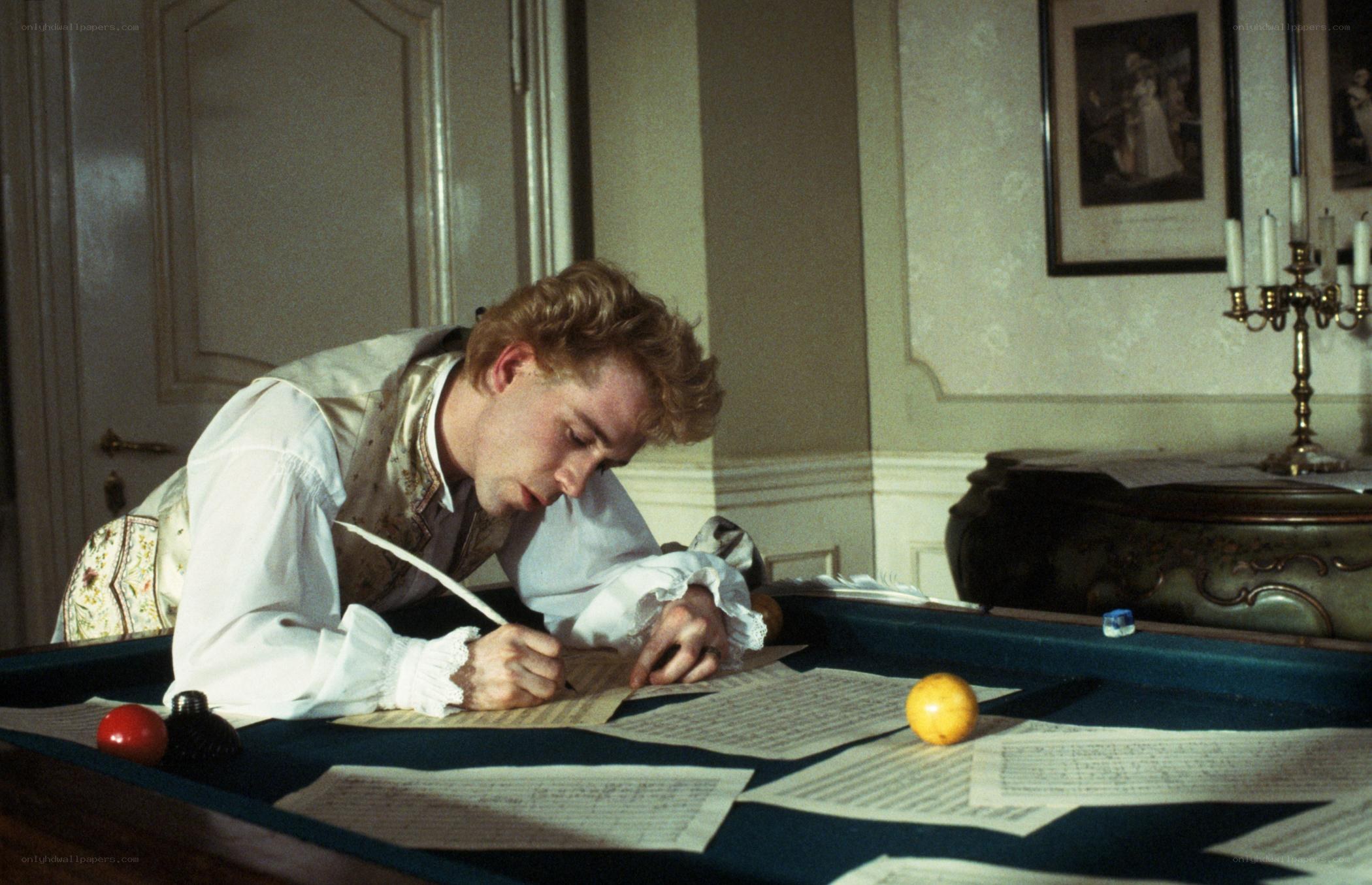 man writing at pool table