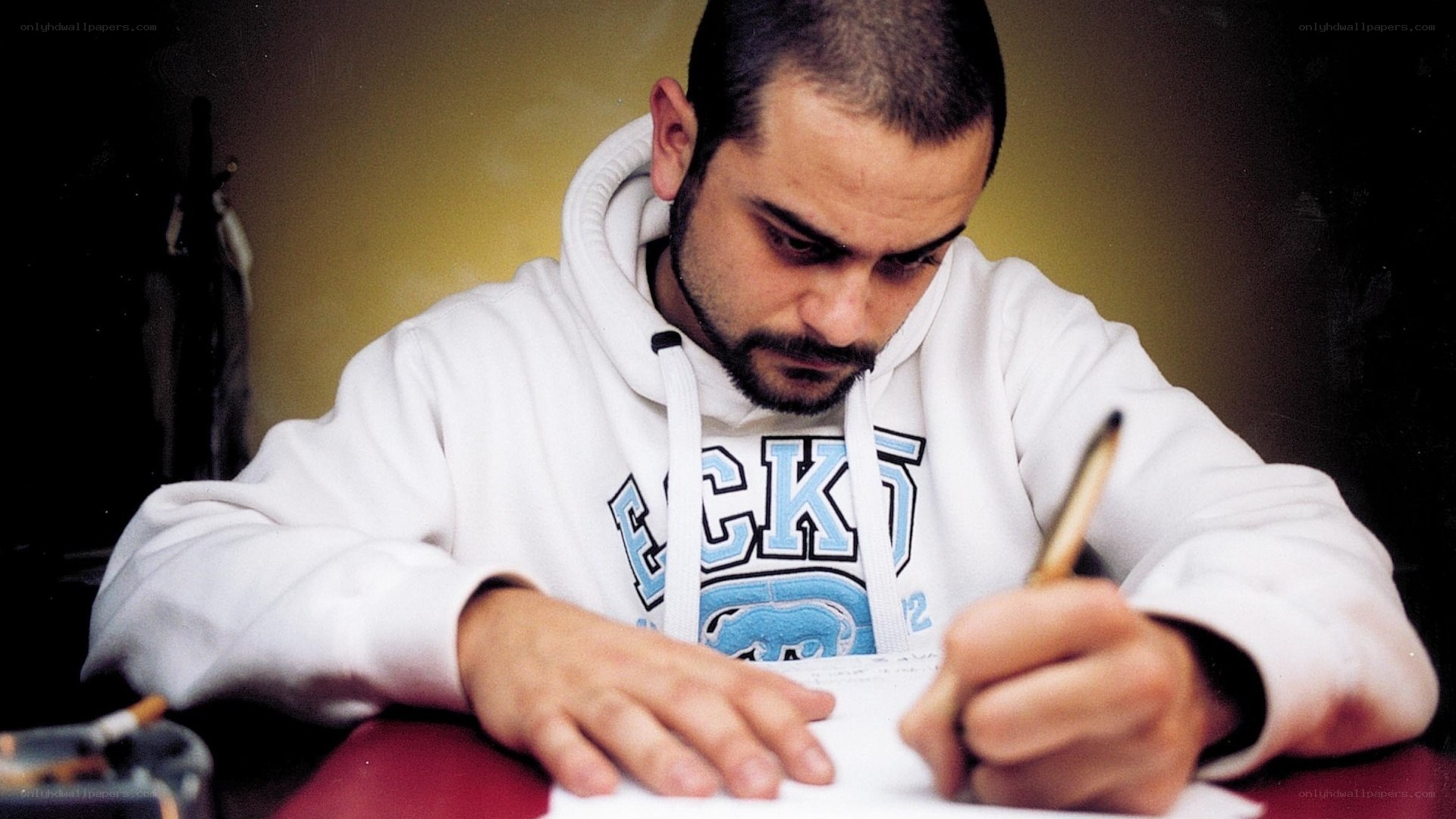 man writing at table