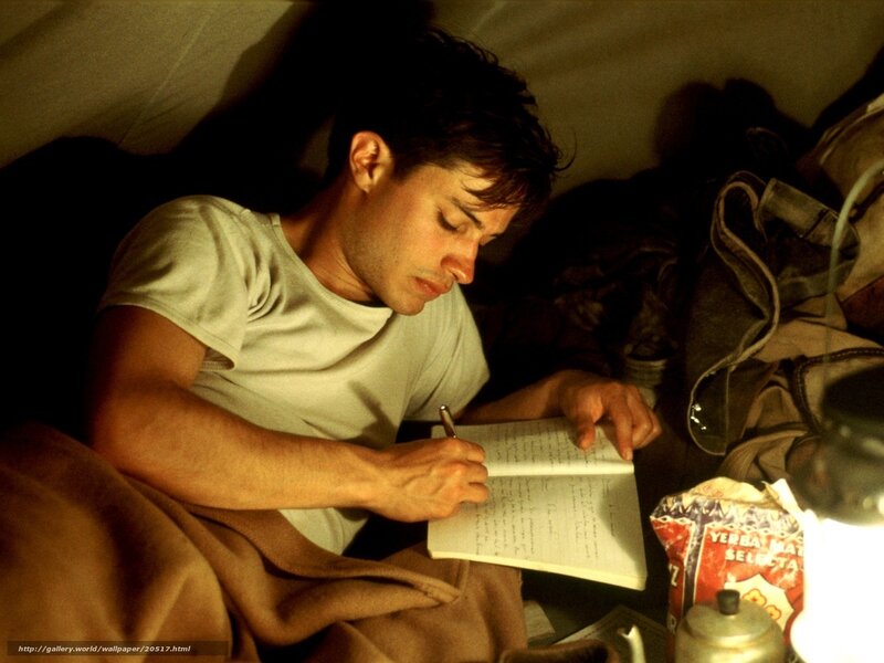 man writing in a notebook