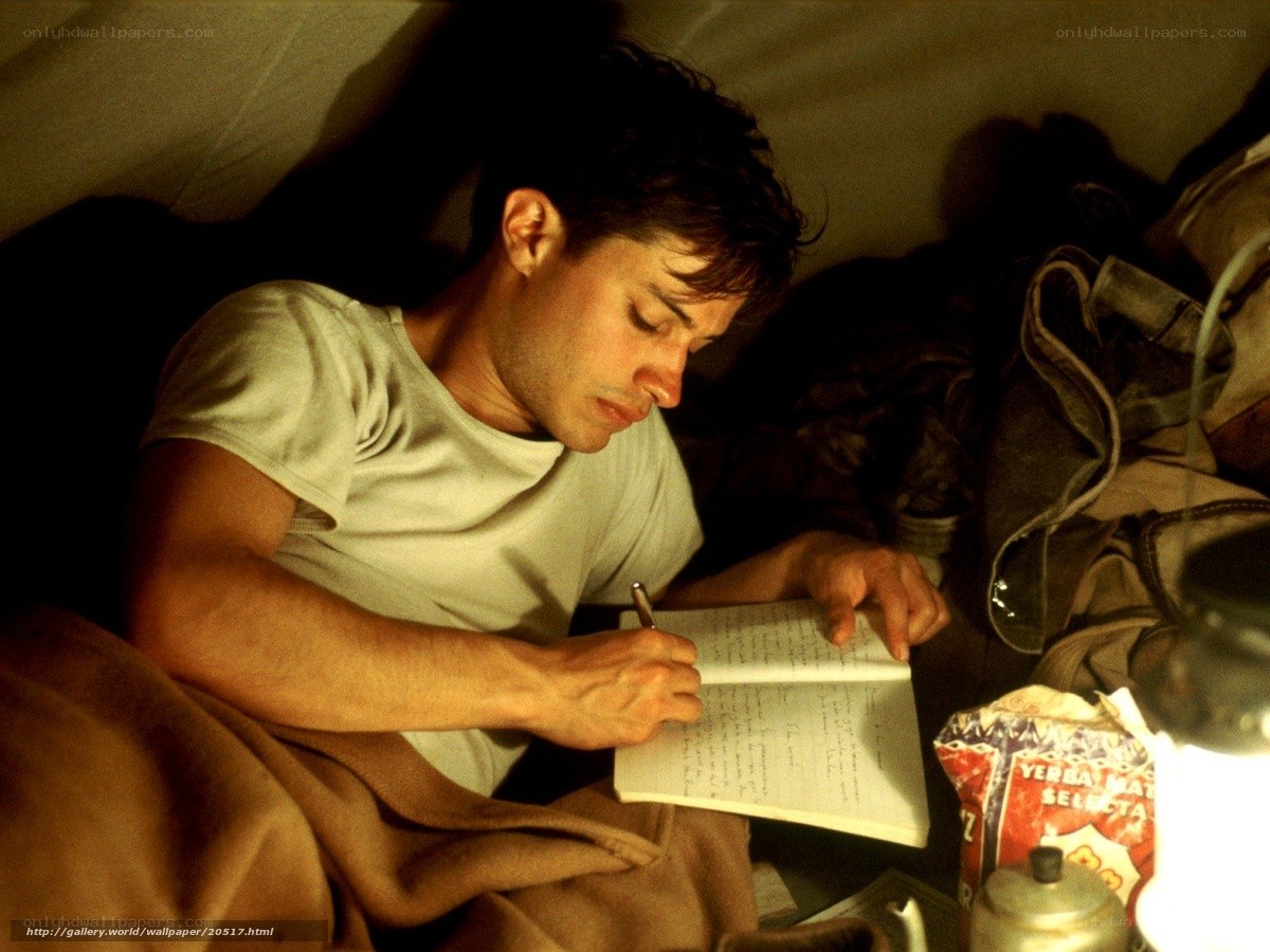 man writing in a notebook