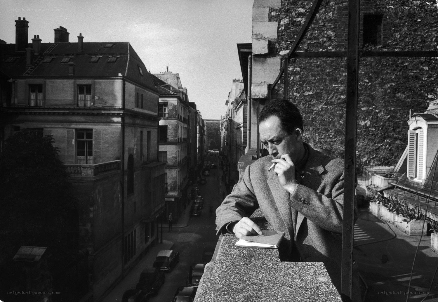 Man writing on a balcony