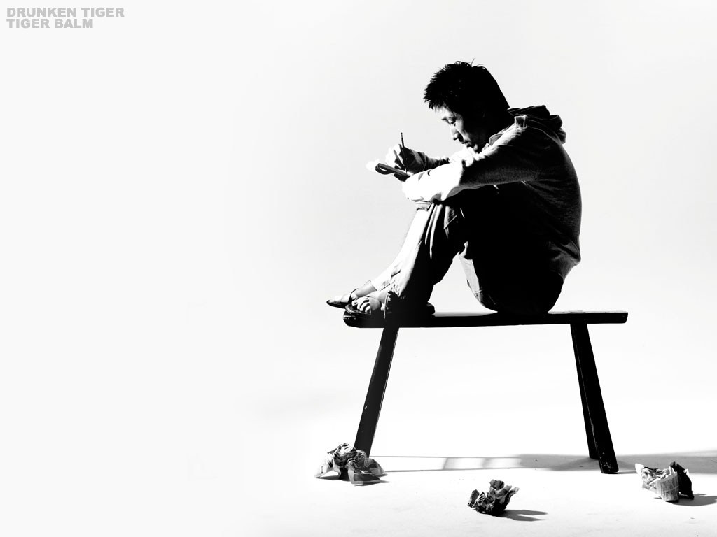 man writing on bench