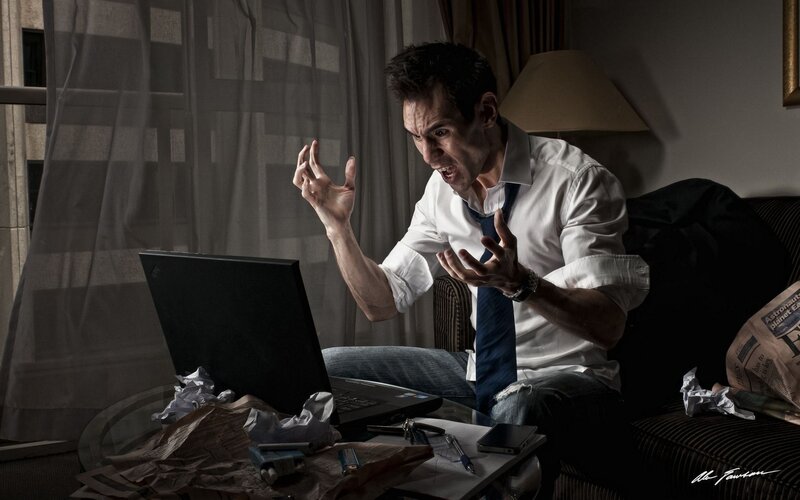 man yelling at laptop
