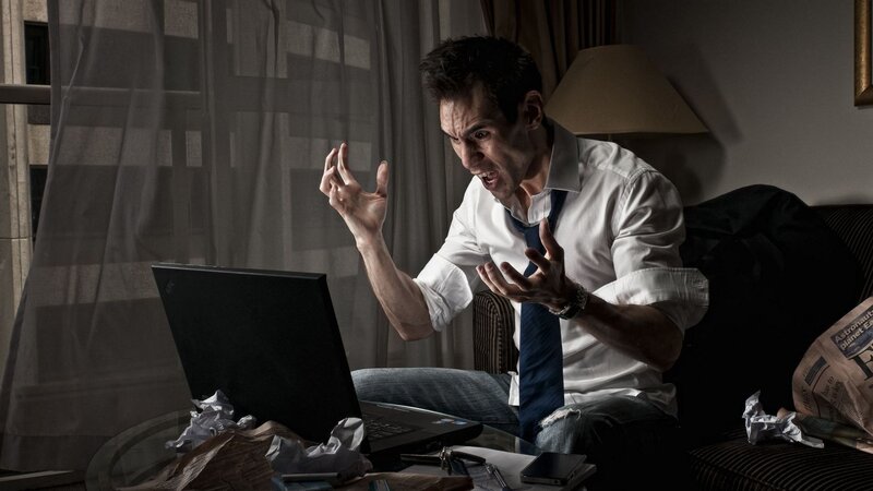 man yelling at laptop