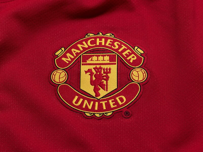 Manchester United crest on red fabric