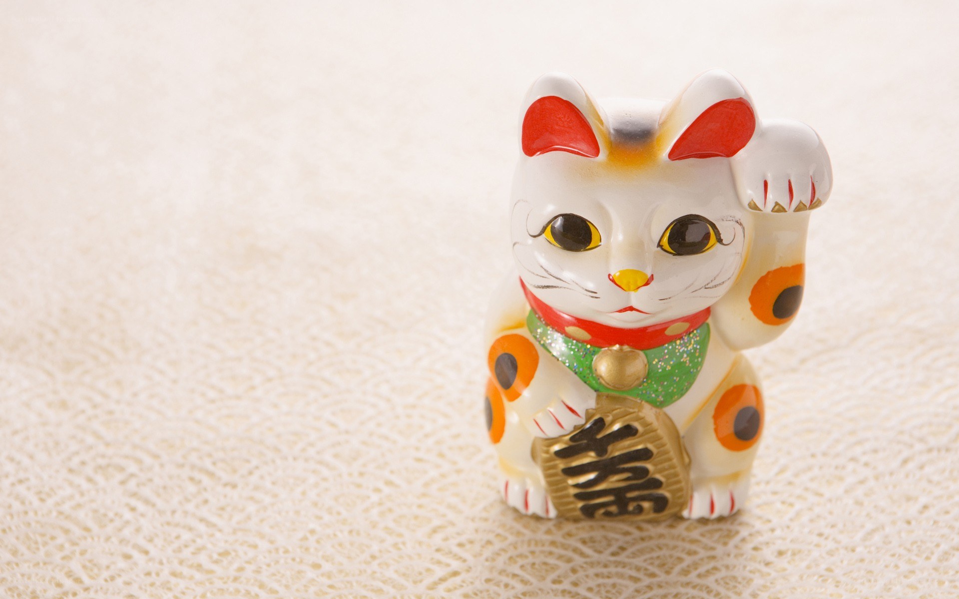Maneki-neko figurine on textured surface