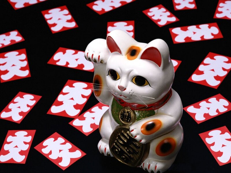 Maneki-neko figurine with lucky charms
