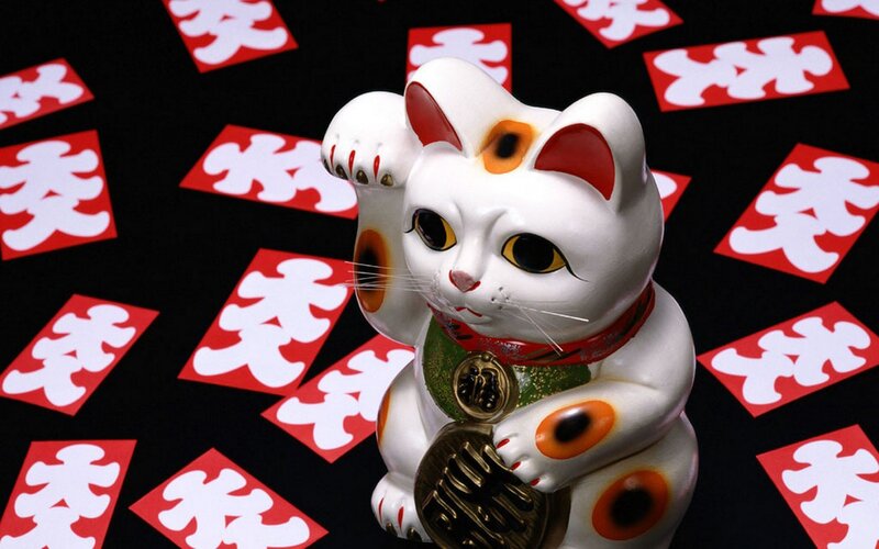 Maneki-neko figurine with lucky symbols