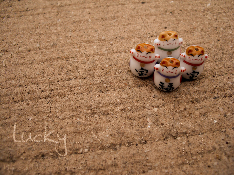 Maneki-neko figurines on sand