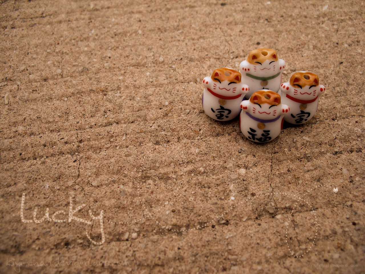 Maneki-neko figurines on sand
