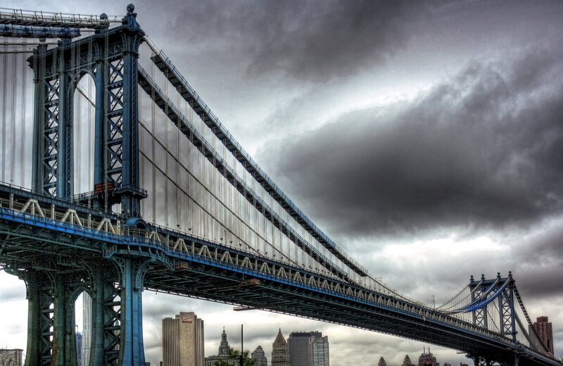 Manhattan Bridge under stormy sky
