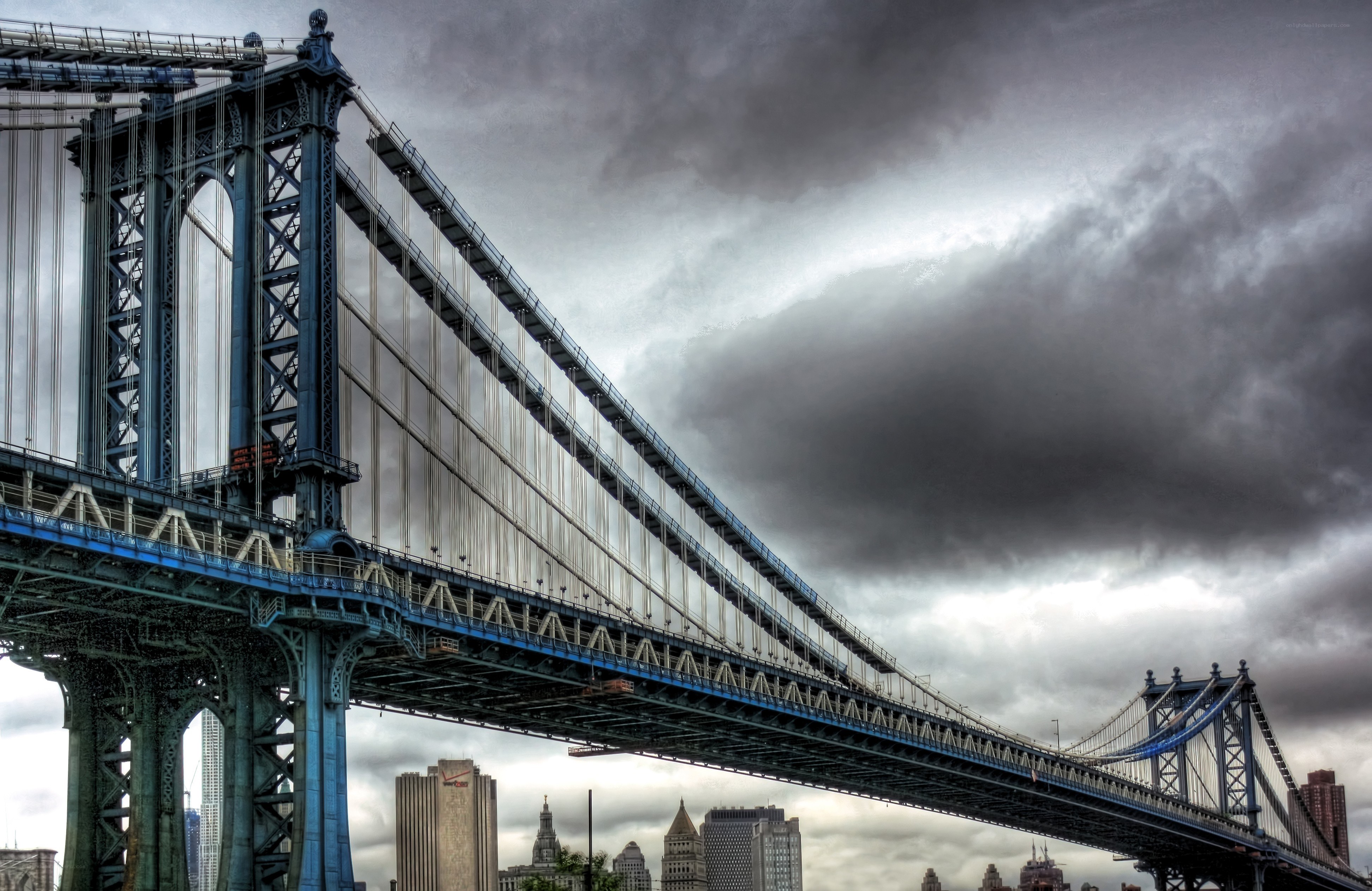 Manhattan Bridge under stormy sky