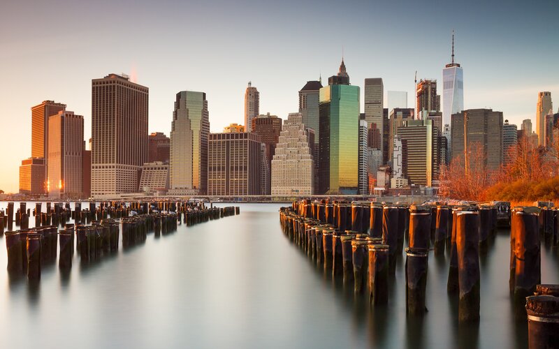 Manhattan Skyline at Sunset — Blue, Serene, Photograph, Skyscrapers, Pilings