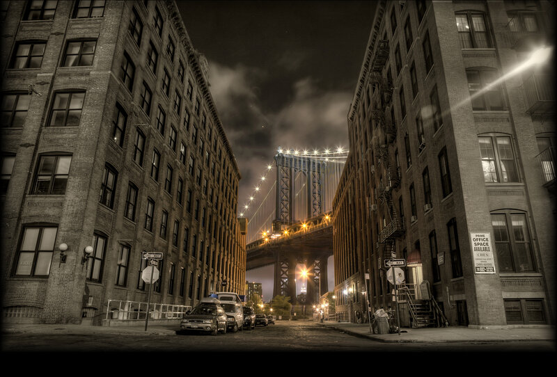 Manhattan street at night with bridge
