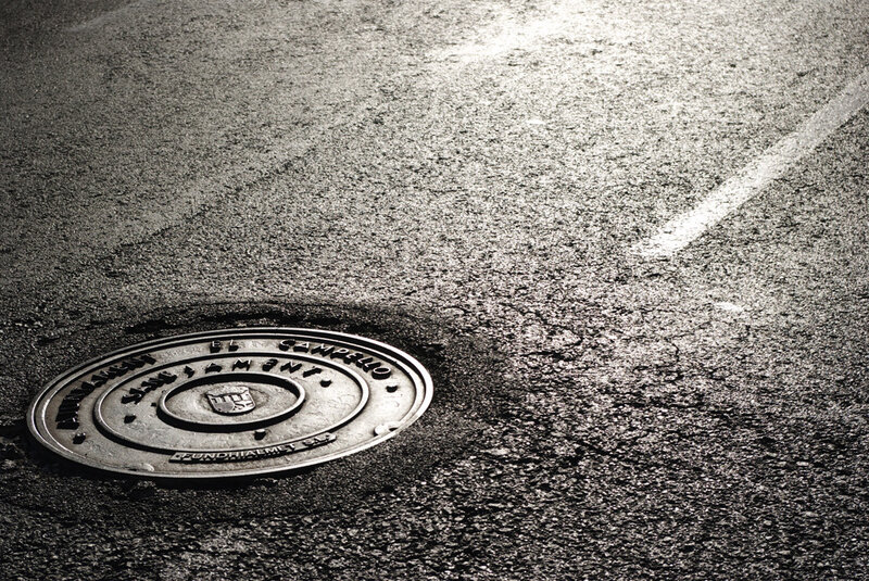 manhole cover on asphalt