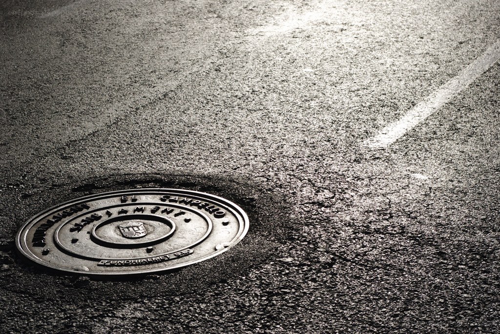 manhole cover on asphalt