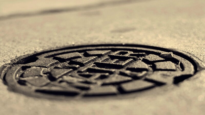 Manhole Cover on Pavement