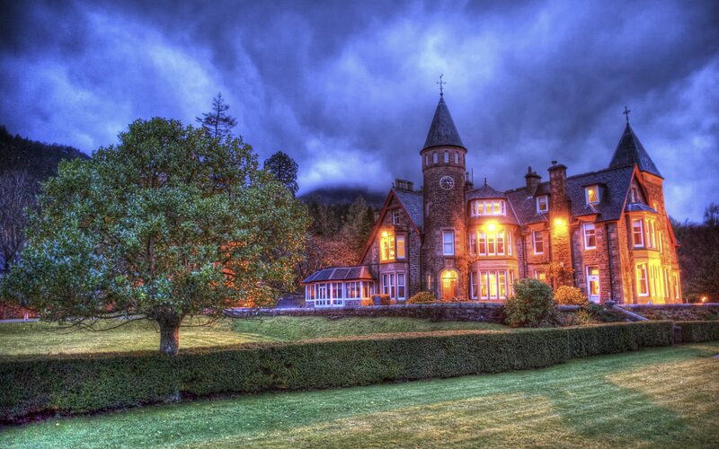 mansion at dusk with stormy sky