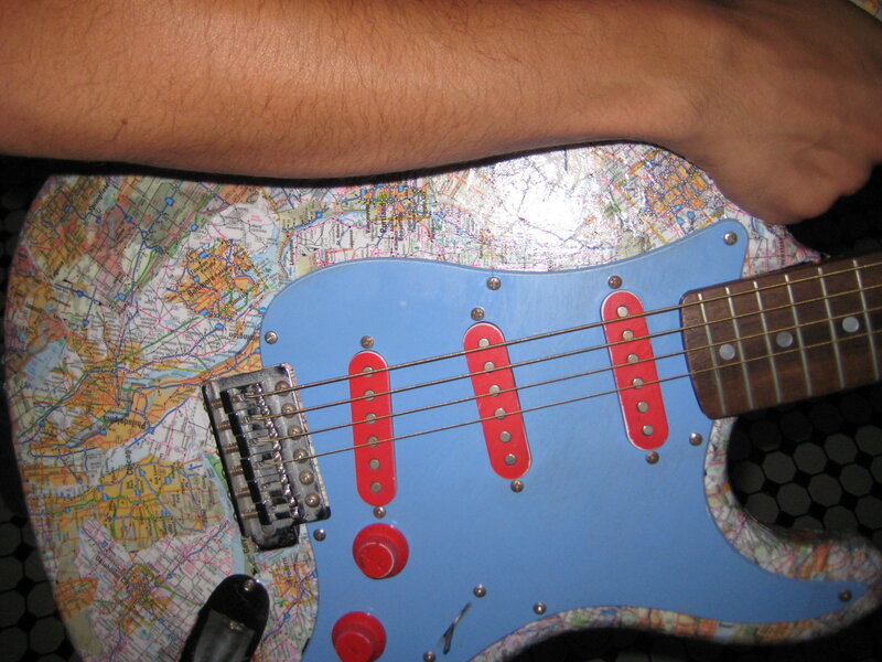 map-decorated electric guitar