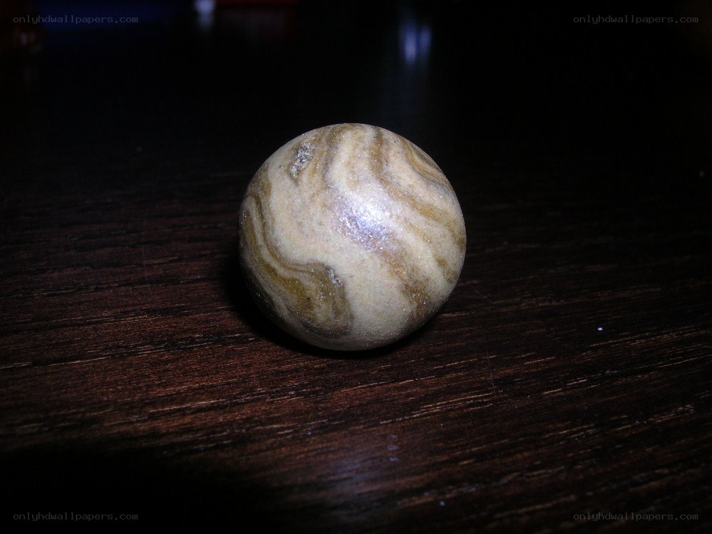 Marble on wooden surface