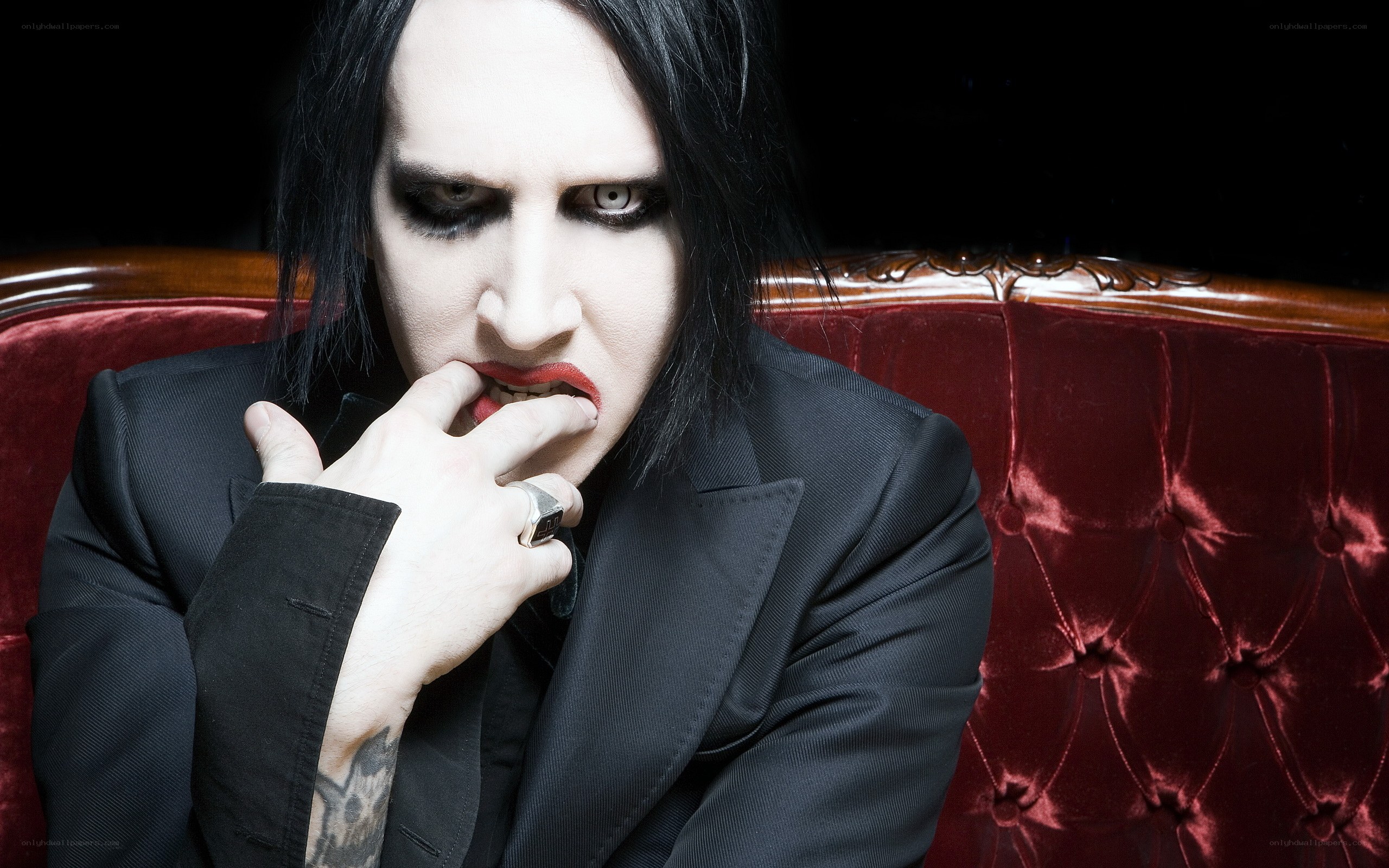 Marilyn Manson on red couch